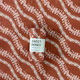 Brick Puakenikeni Lei Swaddle Blanket - Sweet Sweet Honey Hawaii